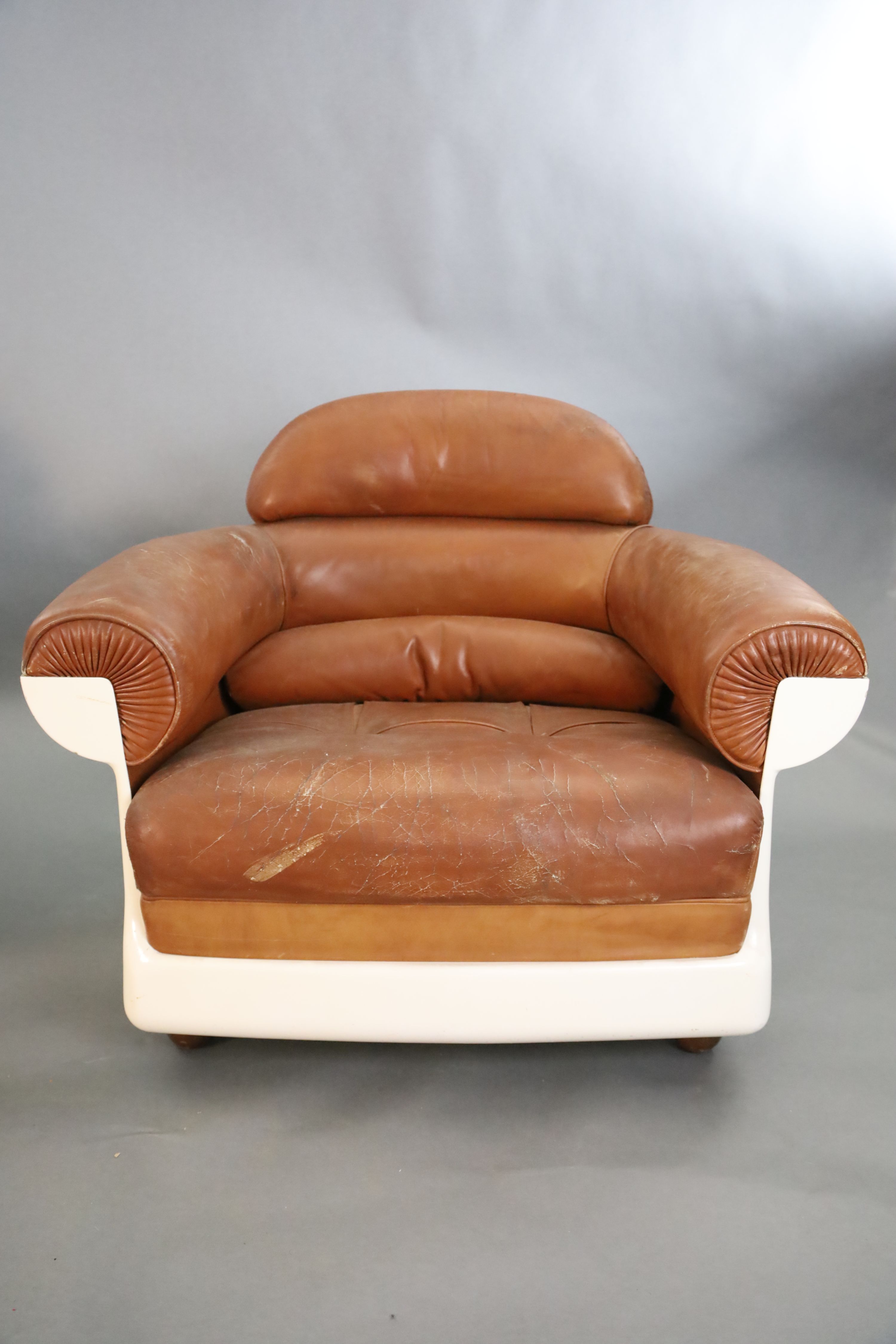 A pair of mid century tan leather and fibreglass tub chairs, possibly French, by Airbourne, W.3ft 1in. D.2ft 7in. H.2ft 8in.